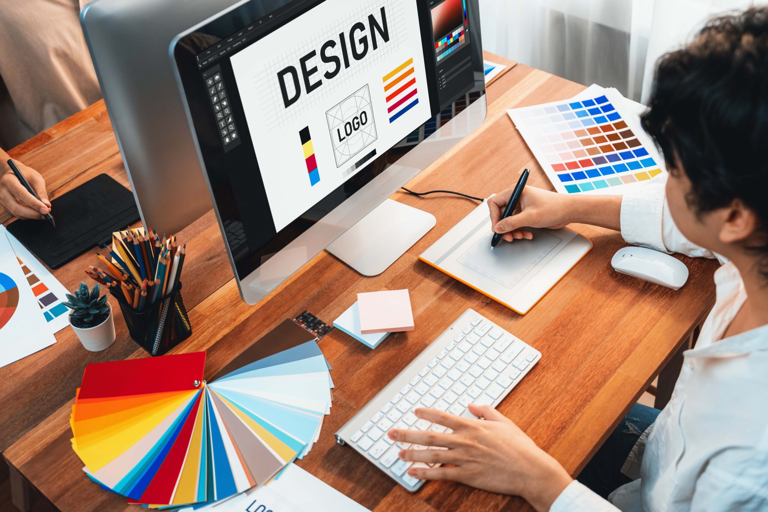 Hands holding a box in hands, thinking process on ways to improve it. Sitting behind the desk. No face. High angle.